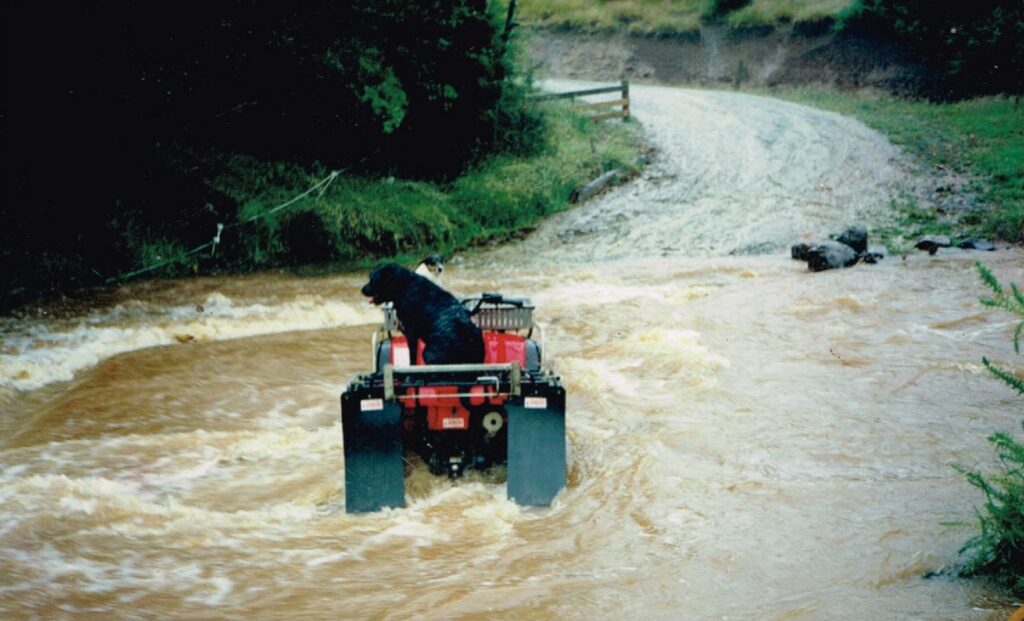 Wade Concrete Bridge with quad bike and dog, rain water coming over the top of the bridge