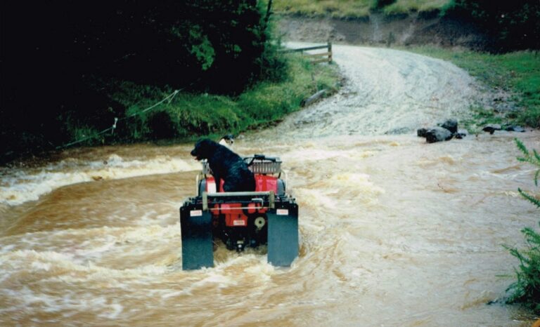 Wade Concrete Bridge with quad bike and dog, rain water coming over the top of the bridge